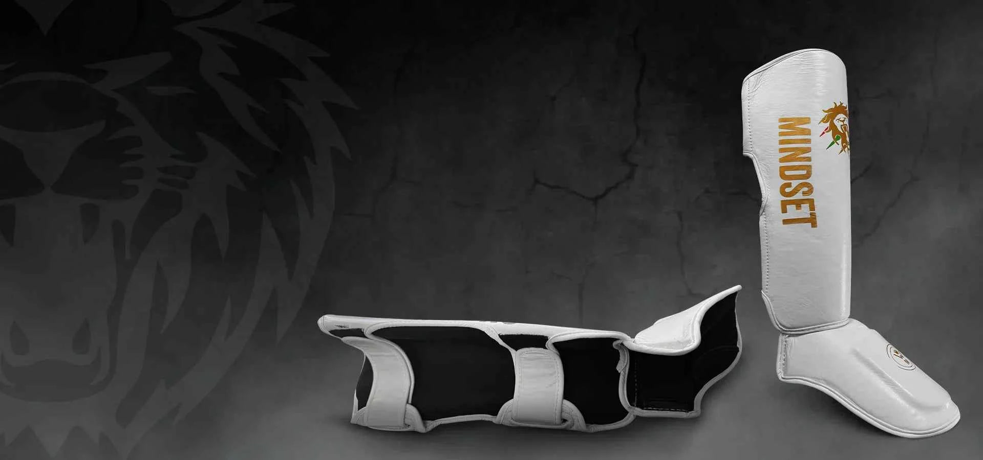 White and black shin guards with 'MINDSET' branding on a dark background162080663620b95195-2