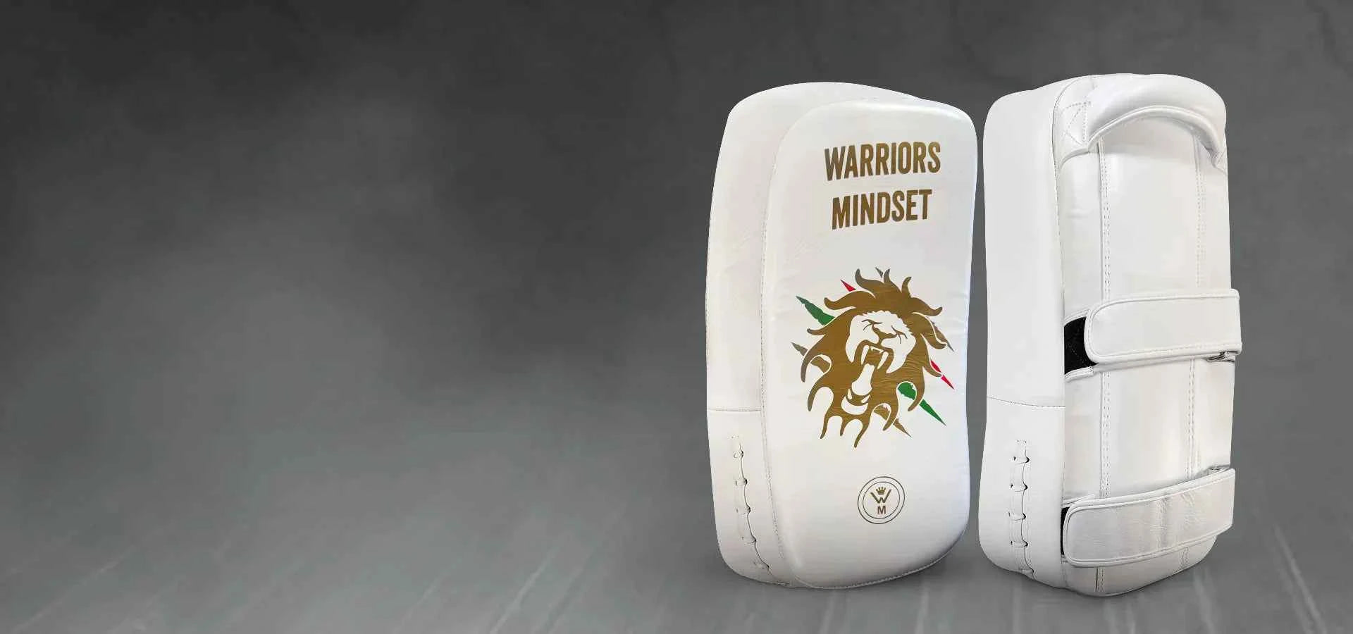 White martial arts knee pads with 'Warriors Mindset' logo on a gray background162080663620b95195-0